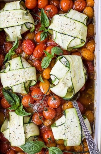 overhead photo of cheese zucchini ravioli in roasted tomato sauce with a spoon in a baking dish