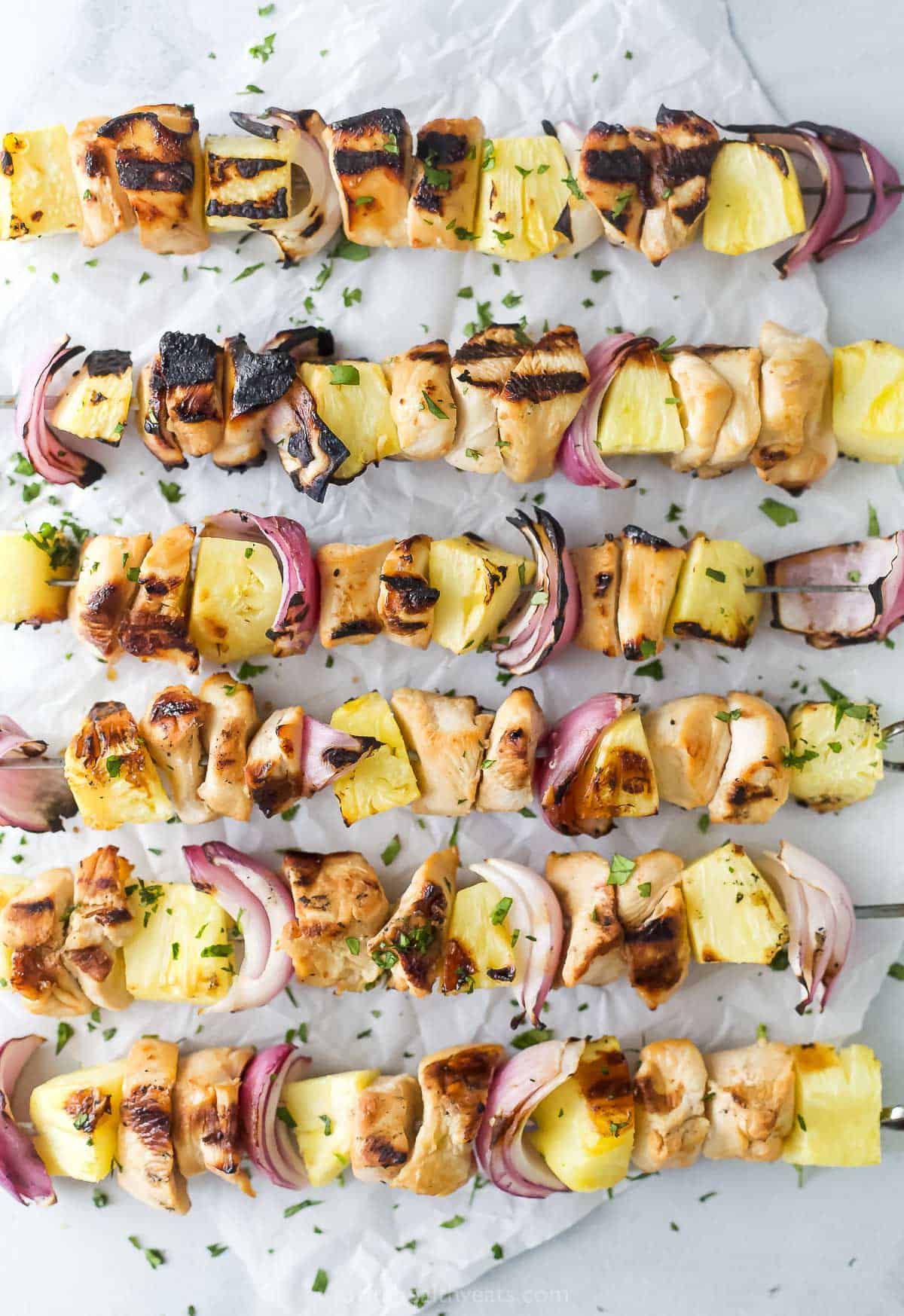 Overhead view of grilled chicken pineapple kabobs with cilantro