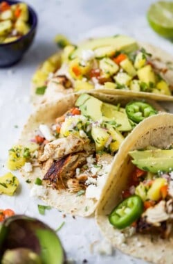 close up photo of easy chipotle chicken tacos topped with pineapple salsa