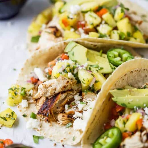 close up photo of easy chipotle chicken tacos topped with pineapple salsa