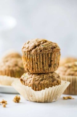 close up of two healthy zucchini muffins stacked on top of each other