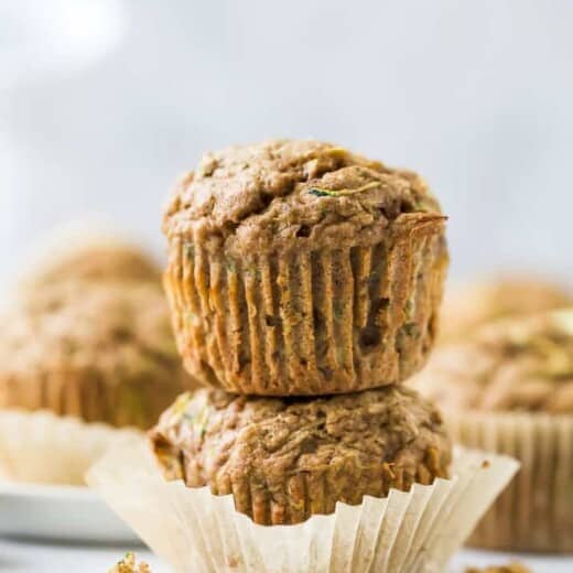 close up of two healthy zucchini muffins stacked on top of each other