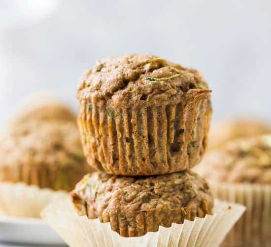 close up of two healthy zucchini muffins stacked on top of each other
