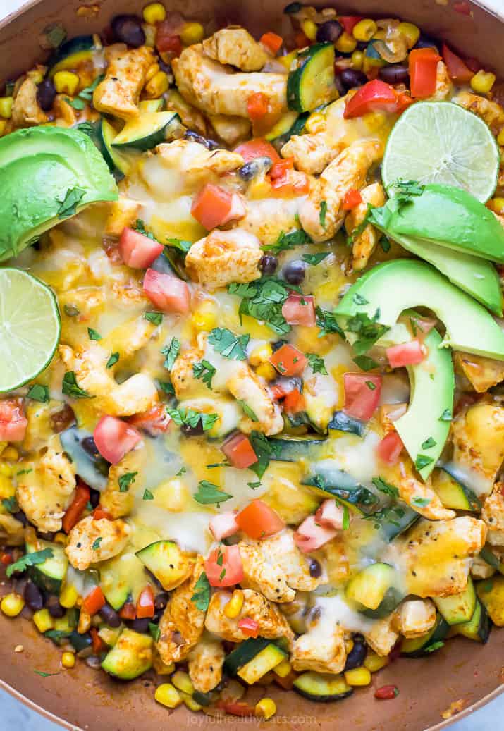 closeup photo of 30 minute zucchini chicken enchilada skillet with avocados on top