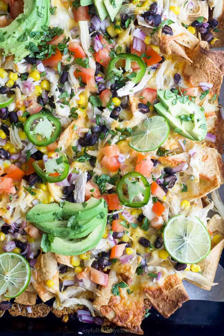 easy 20 minute sheet pan chicken nachos topped with avocado