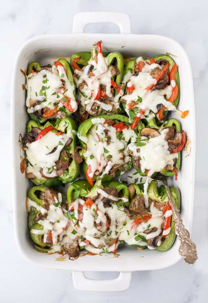 overhead view of easy keto philly cheesesteak stuffed peppers in a baking dish