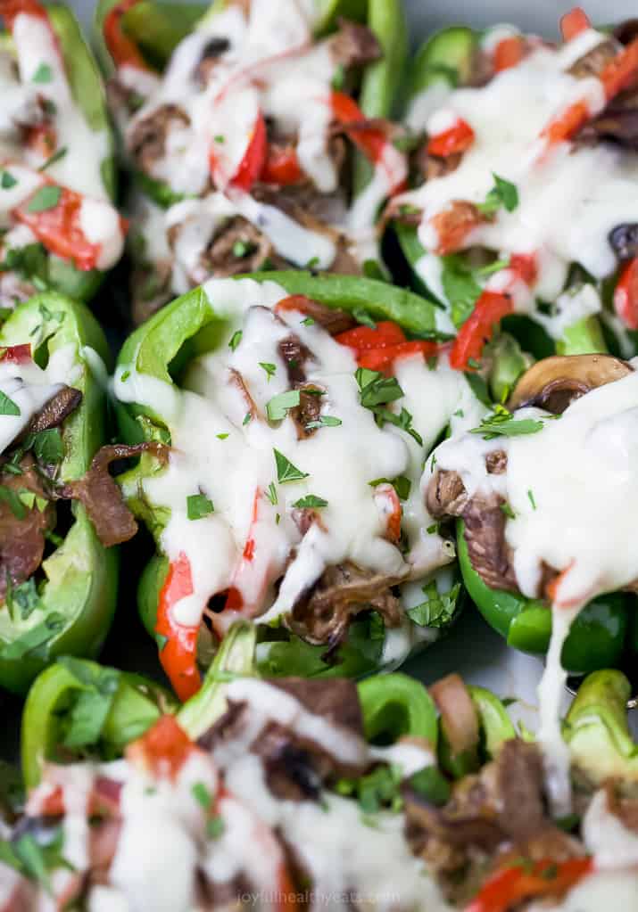 close up view of easy keto philly cheesesteak stuffed peppers in a baking dish