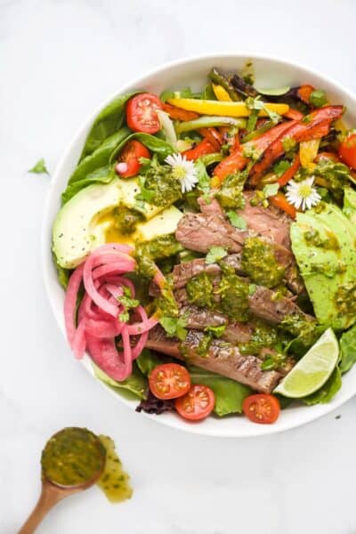 grilled fajita steak salad with chimichurri dressing in a bowl