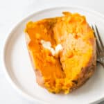 close up photo of instant pot sweet potato cut in half with butter