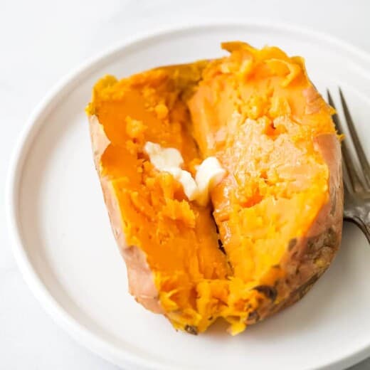 close up photo of instant pot sweet potato cut in half with butter