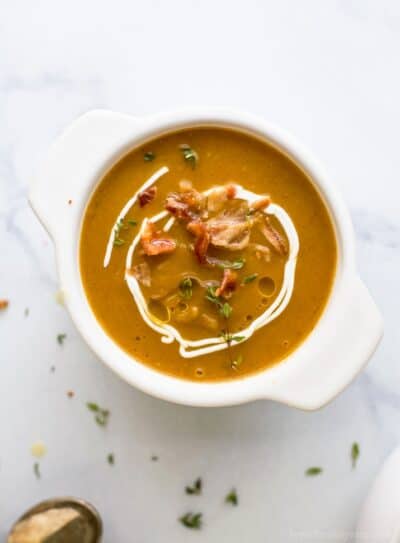 instant pot autumn squash soup in a bowl topped with yogurt