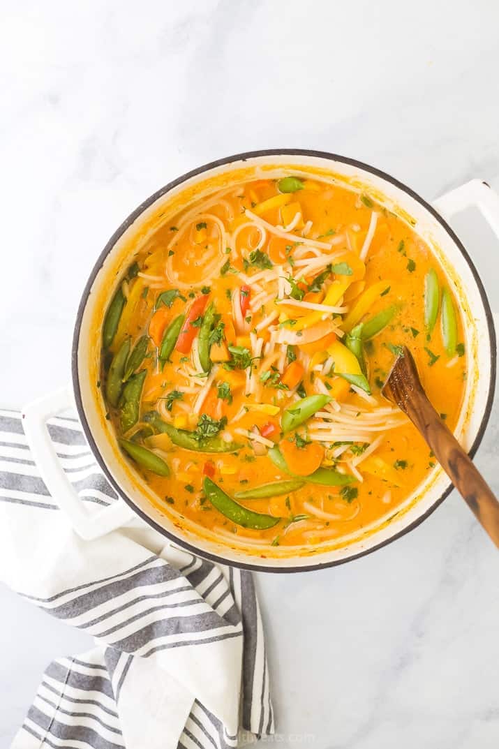 easy 30 minute vegetable thai noodle soup in a soup pot with a spoon