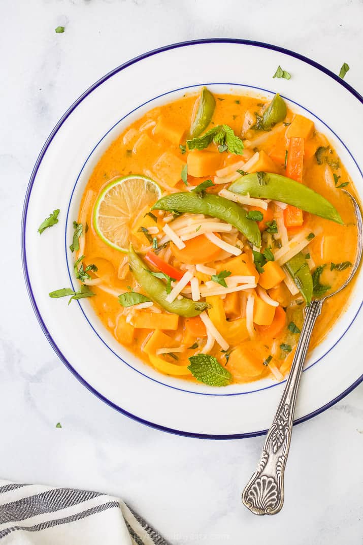 close up photo of easy 30 minute vegetable thai noodle soup in a bowl with a spoon