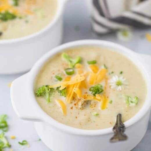 side photo of broccoli cheese soup topped with cheese