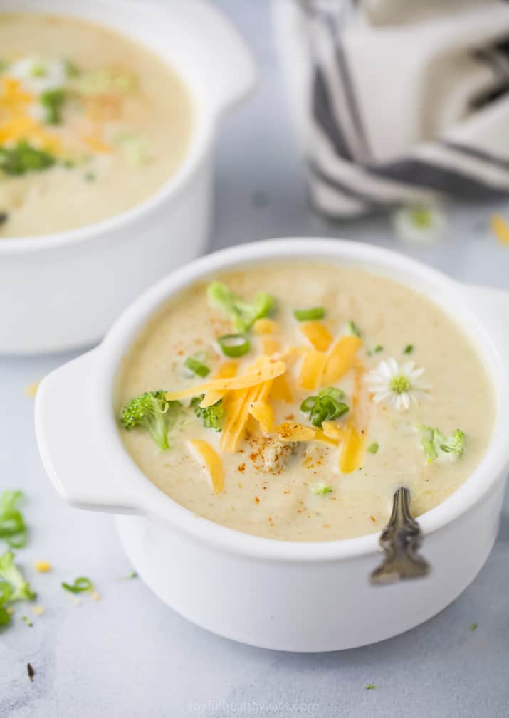 side photo of broccoli cheese soup topped with cheese
