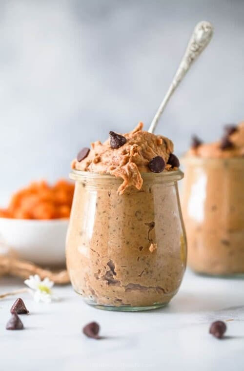 healthy vegan chocolate chip pumpkin cookie dough in a jar with a spoon