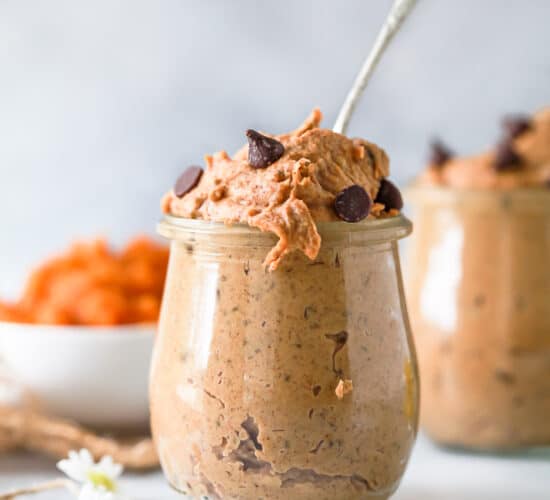 healthy vegan chocolate chip pumpkin cookie dough in a jar with a spoon