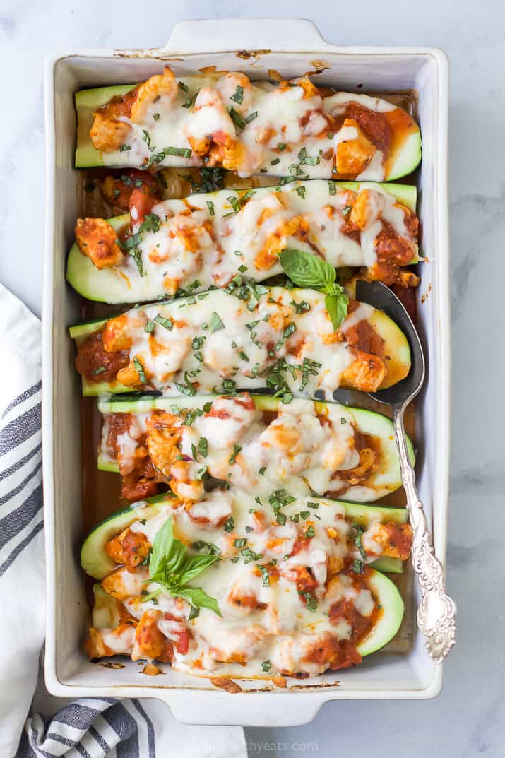 the best easy chicken parmesan zucchini boats in a baking dish