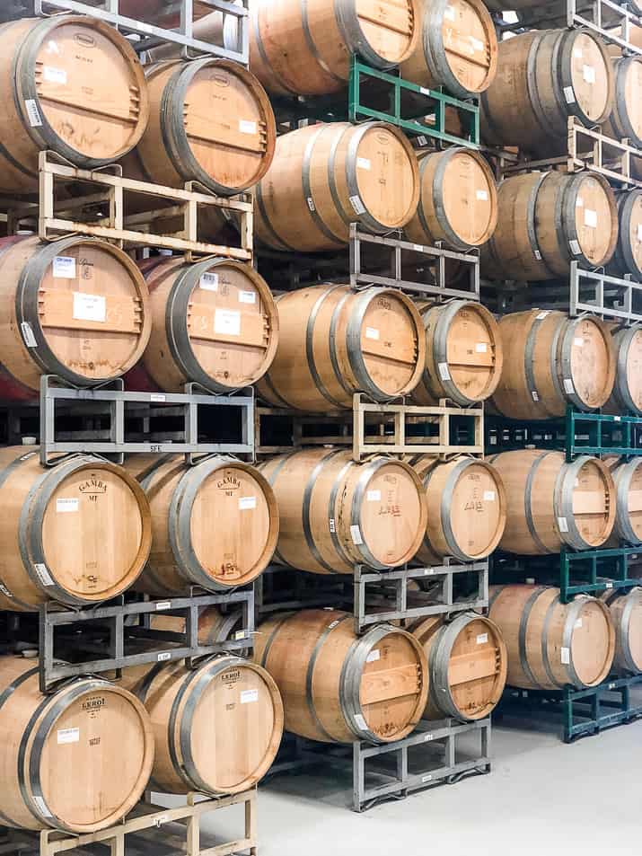 wine barrels stacked in a cooling area at a winery in napa valley california