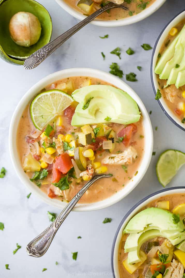 the ultimate creamy crockpot chicken tortilla soup in a bowl