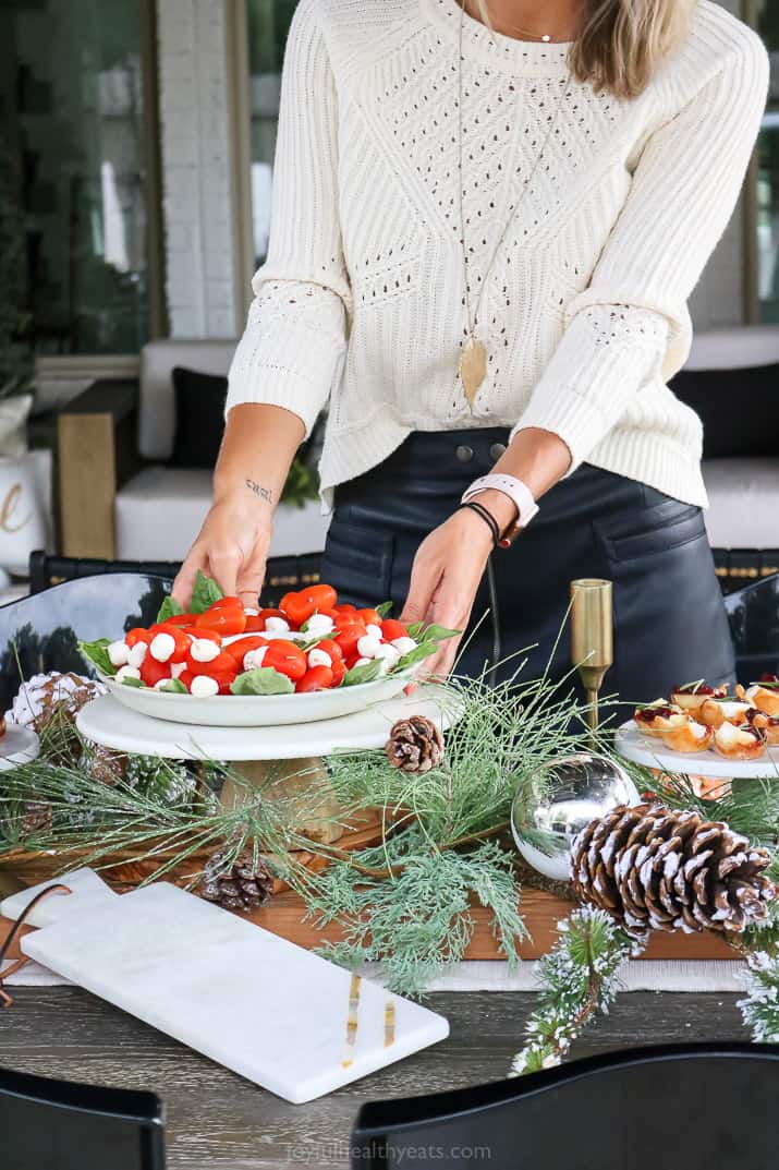 placed an appetizer dish on a holiday decorated table