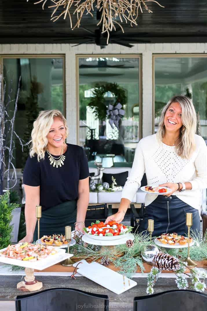 photo of two women setting a holiday entertaining table