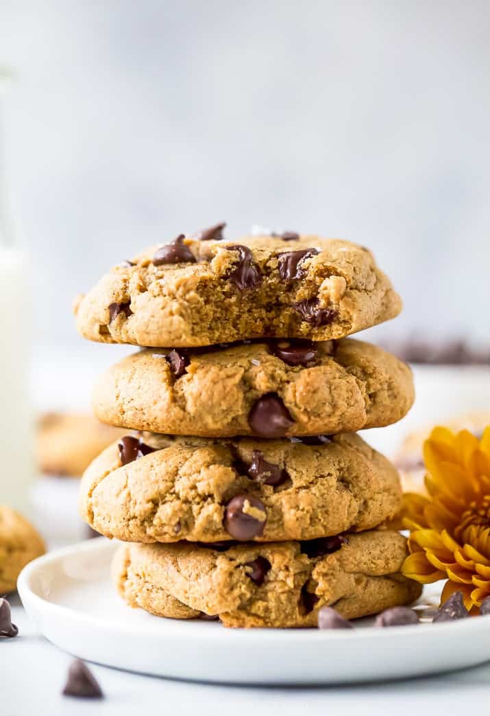 closeup photo of vegan pumpkin chocolate chip cookies stacked on top of each other