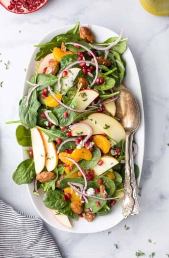 best spinach salad with apple pecans and gorgonzola cheese on a plate