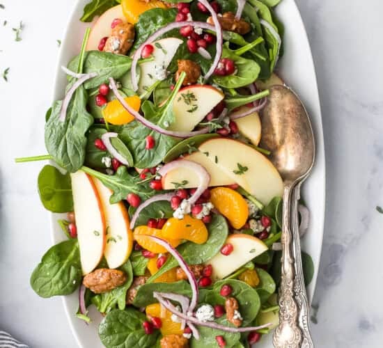 best spinach salad with apple pecans and gorgonzola cheese on a plate