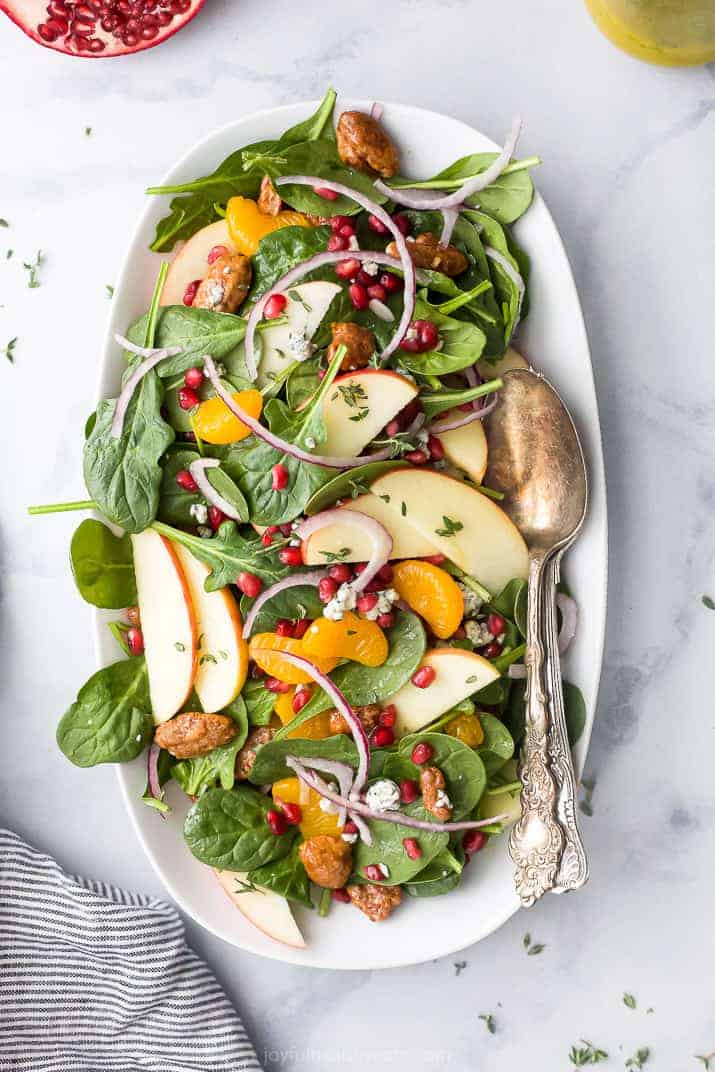 best spinach salad with apple pecans and gorgonzola cheese on a plate