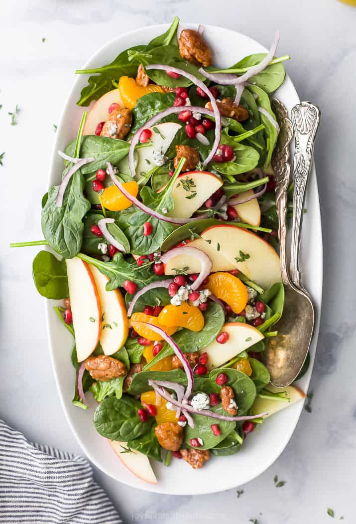 best spinach salad with apple pecans and gorgonzola cheese on a plate