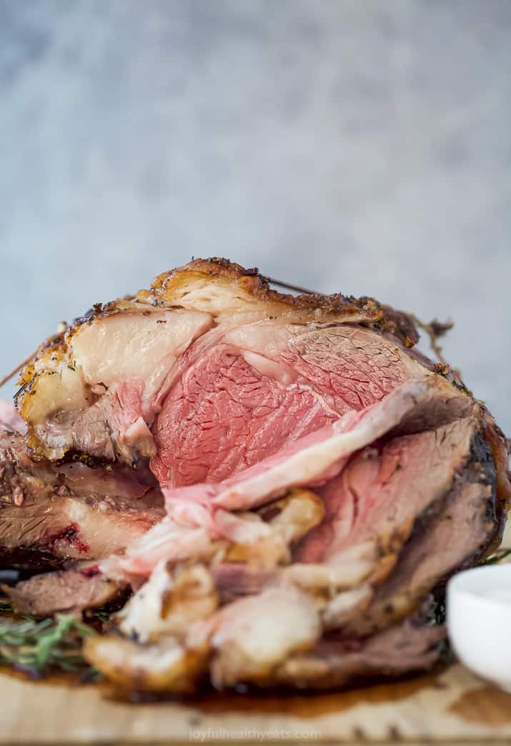 finished perfect garlic herb prime rib roast on a cutting board