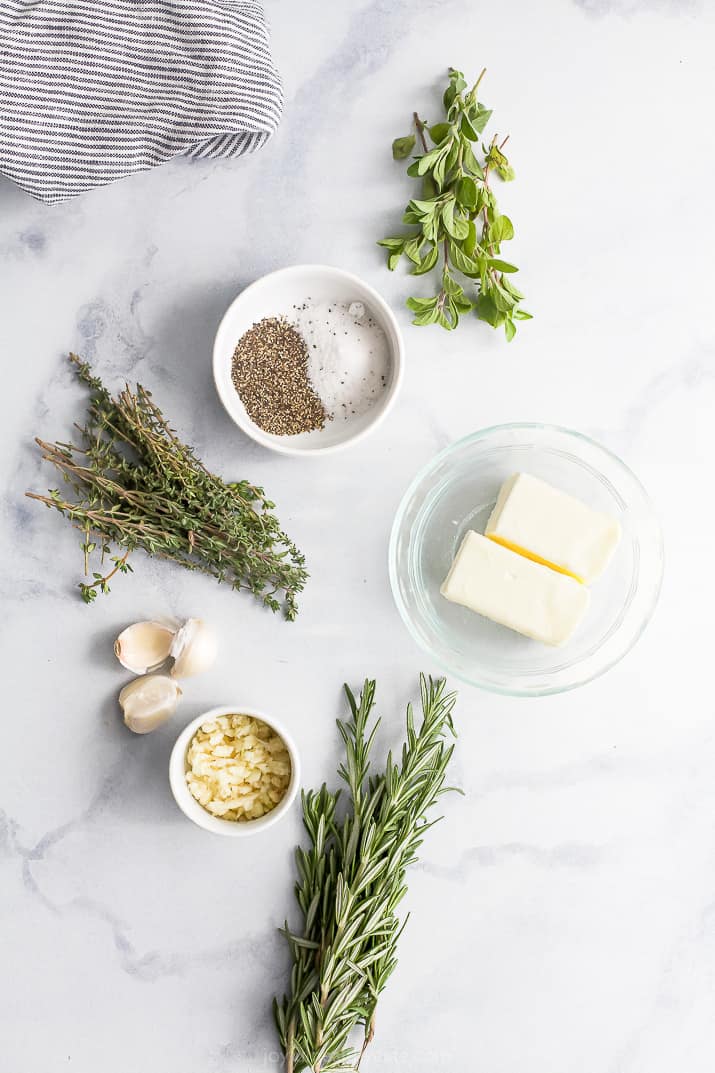 Ingredients for garlic herb butter on countertop.