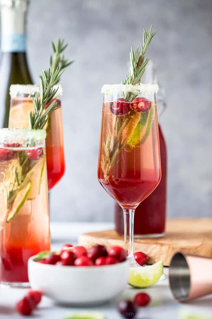 easy cranberry mimosa recipe in a glass with garnish