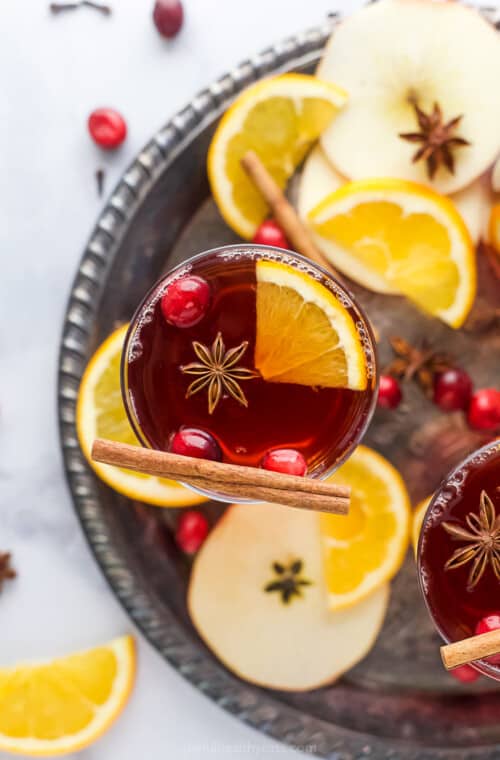 overhead photo of spiked cranberry mulled apple cider on a tray