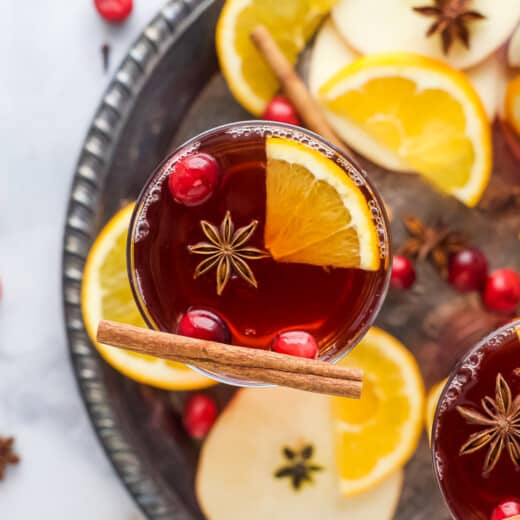 overhead photo of spiked cranberry mulled apple cider on a tray