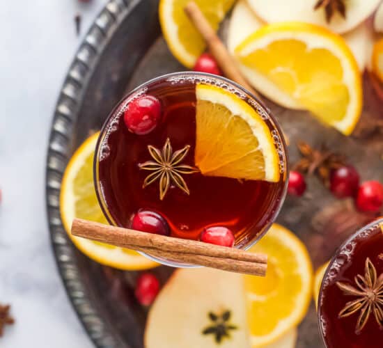 overhead photo of spiked cranberry mulled apple cider on a tray