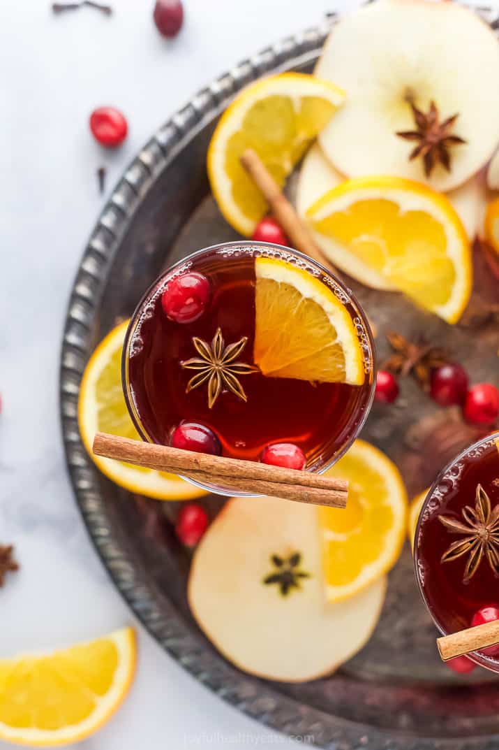 overhead photo of spiked cranberry mulled apple cider on a tray