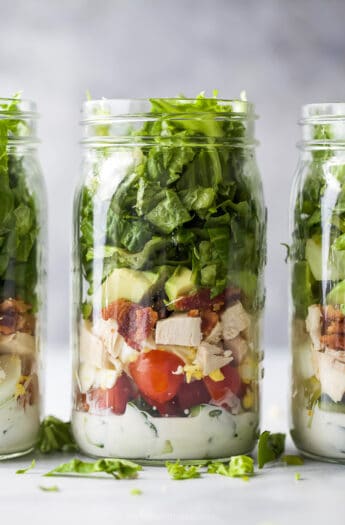 closeup of a mason jar filled with chicken cobb salad recipe with ranch dressing