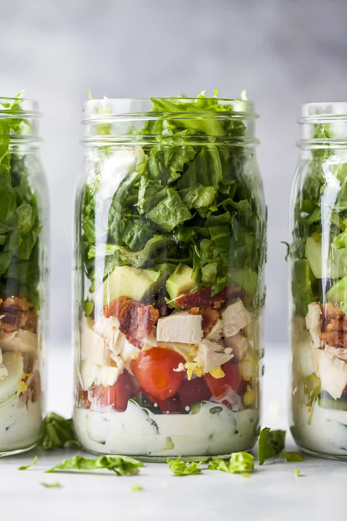 closeup of a mason jar filled with chicken cobb salad recipe with ranch dressing