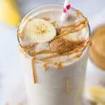 close up photo of creamy peanut butter banana smoothie with peanut butter drizzle