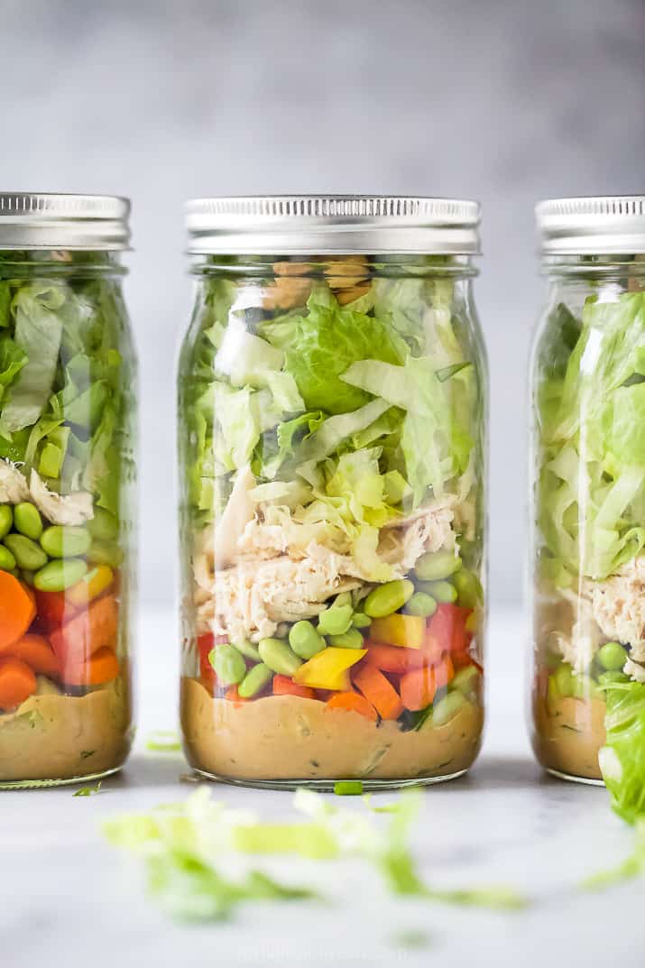 the best thai chicken mason jar salads with a spicy peanut dressing