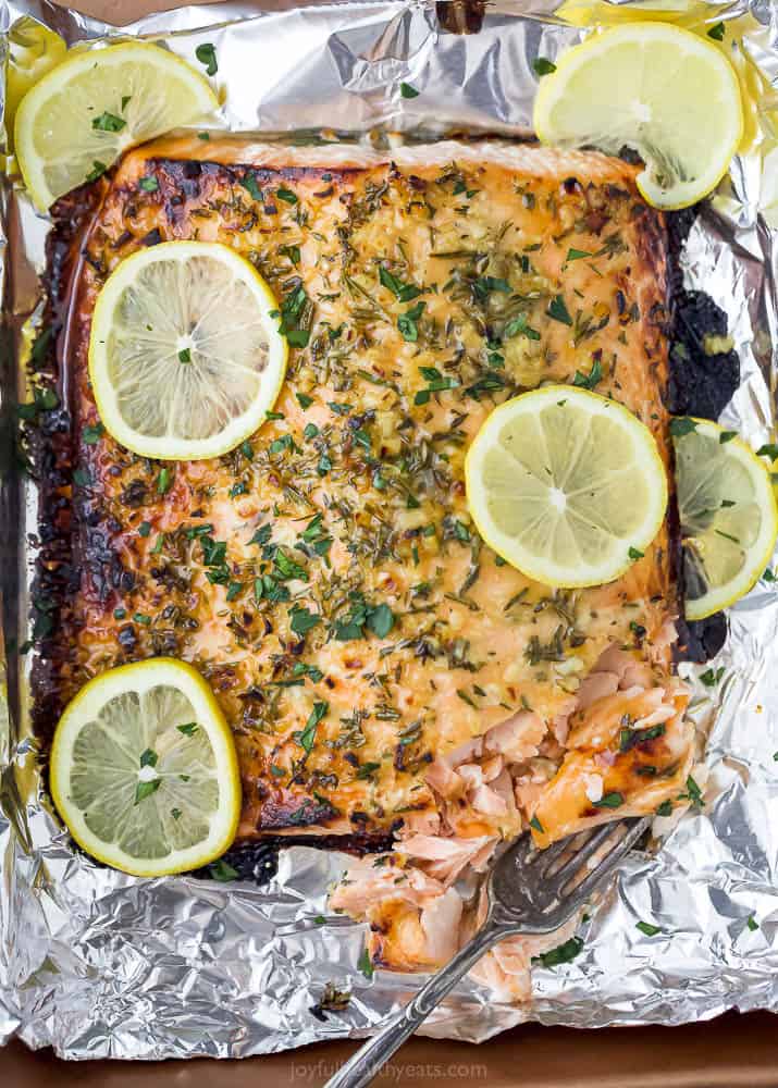 Baked honey garlic salmon in foil with a fork.