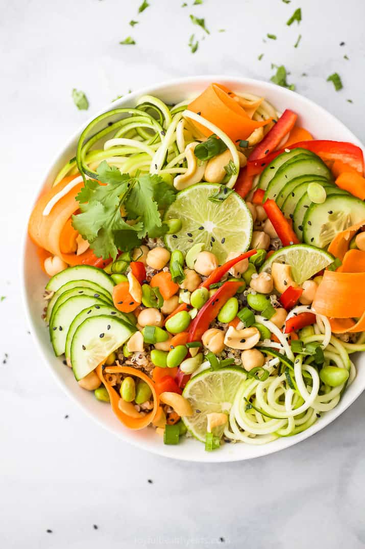 close up of crunchy vegetarian thai quinoa salad with peanut dressing in a bowl