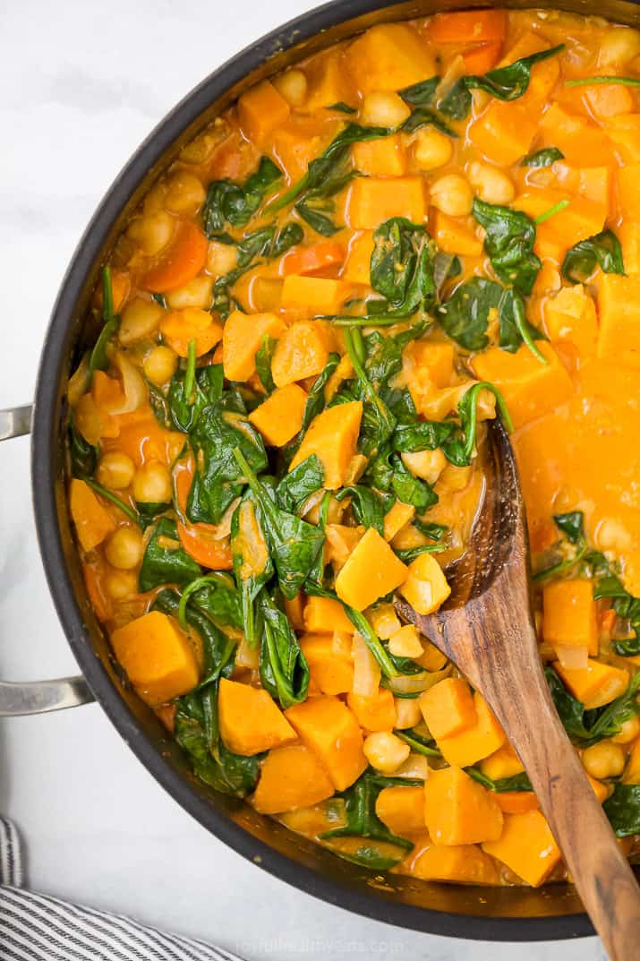 close up photo of vegan sweet potato chickpea curry in a pot