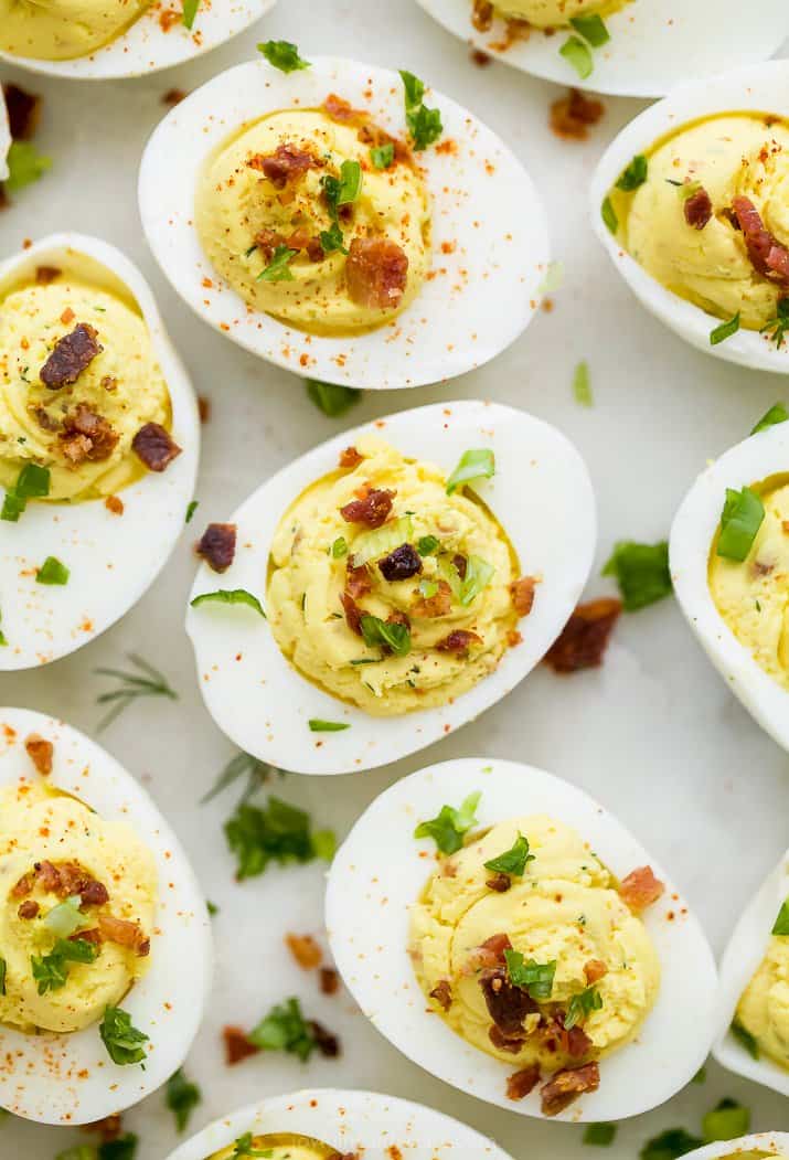 close up of classic deviled eggs with bacon topped with chives