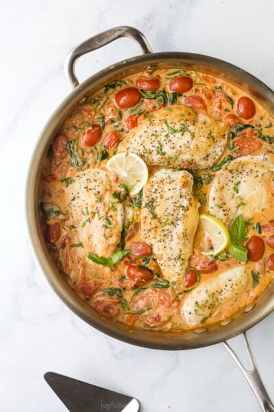 overhead photo of creamy tuscan chicken in a pan