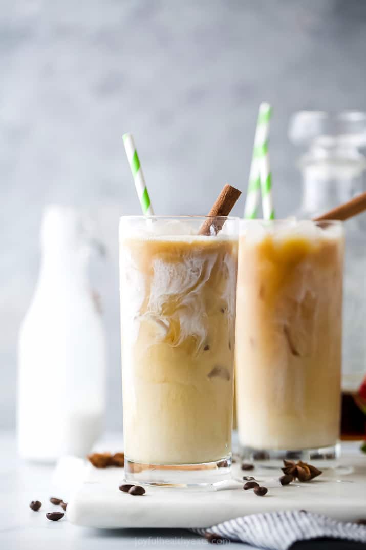 a glass filled with easy iced chai tea latte with a straw in it