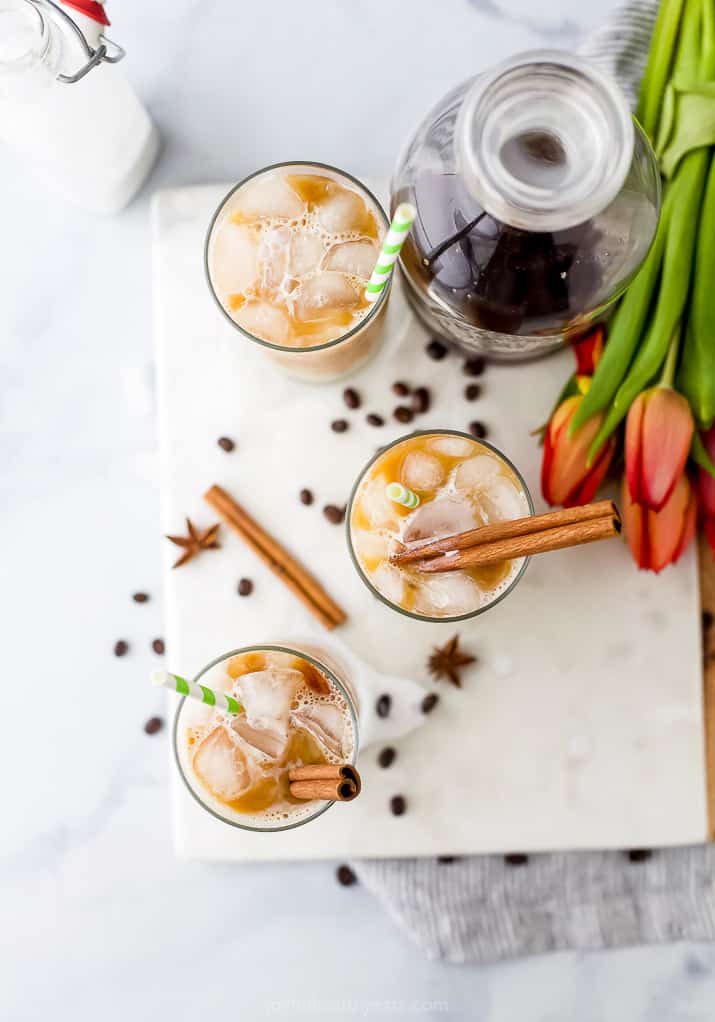 overhead photo of cups filled with iced chai tea latte recipe