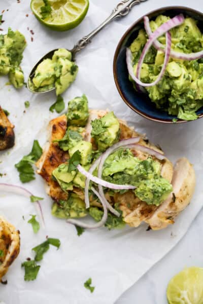 overhead photo of grilled cilantro lime chicken with avocado salsa